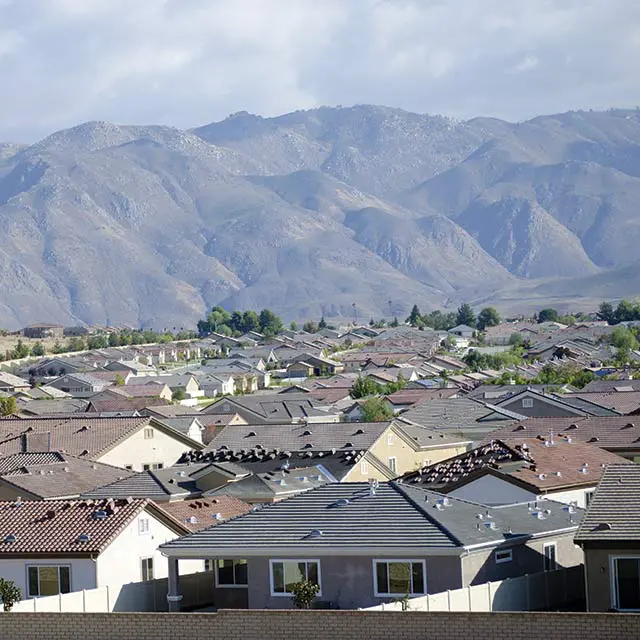 Suburban rooftops with mountain backdrop