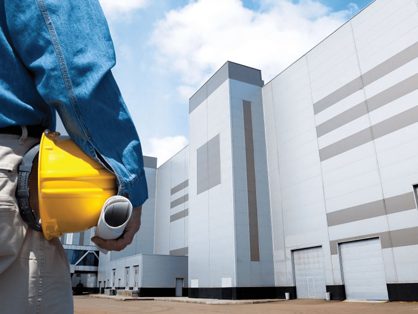 Worker at construction site near large building