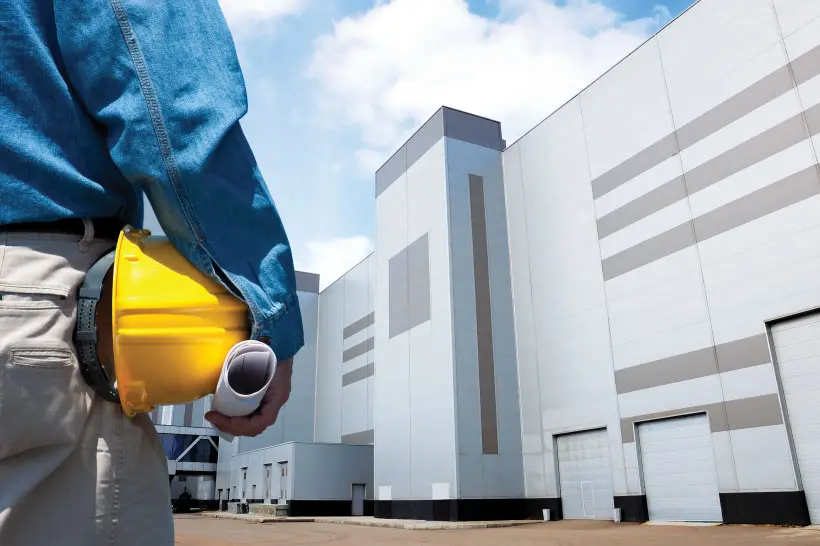Construction worker at modern factory site